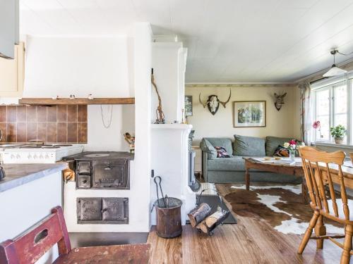 a kitchen and living room with a couch and a table at Holiday Home Lidelund by Interhome in Tingsryd