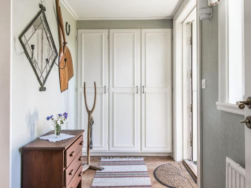 a hallway with a dresser and a door at Holiday Home Lidelund by Interhome in Tingsryd