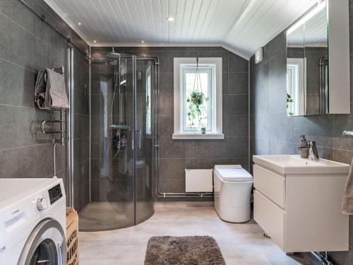 a bathroom with a shower and a toilet and a sink at Holiday Home Gapern by Interhome in Killstad
