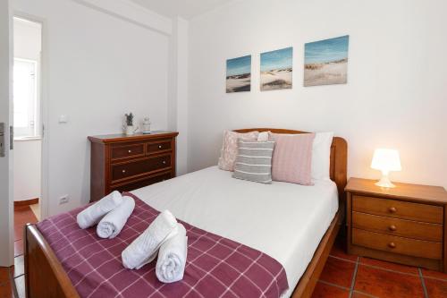 1 dormitorio con 1 cama con toallas en Villa Juno, en Atouguia da Baleia