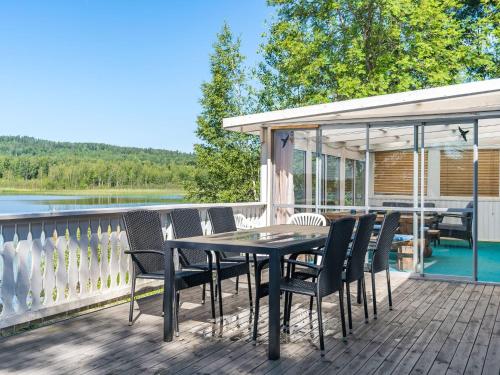 a patio with a table and chairs on a deck at Chalet Uskeboda - VML215 by Interhome in Nora