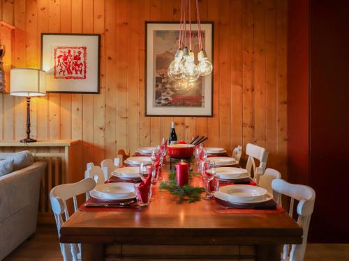 a long wooden table with chairs and a dining room at Apartment Argentière 8 by Interhome in Villars-sur-Ollon