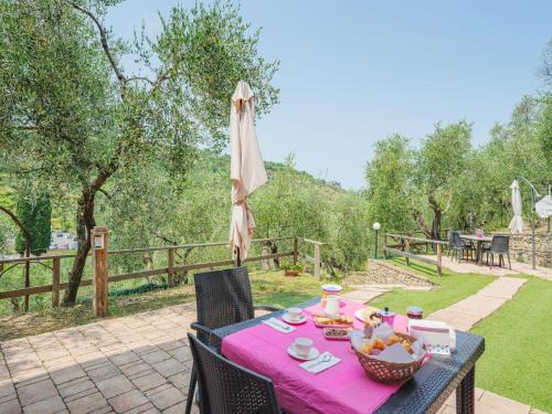 a table with a pink table cloth on a patio at Holiday Home Villetta Linara by Interhome in Sestri Levante