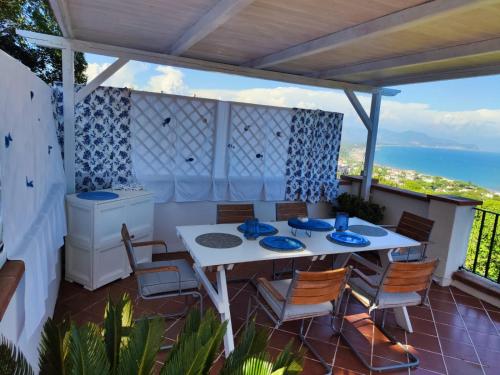 une terrasse avec une table et des chaises et l'océan dans l'établissement Pino Marino, à San Felice Circeo