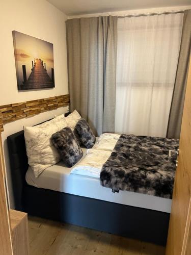 a bedroom with a bed with two dogs laying on it at Haus Colorado am Gaisberg in Scheffau am Wilden Kaiser