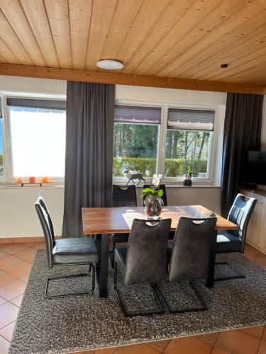 a dining room with a wooden table and chairs at Haus Colorado am Gaisberg in Scheffau am Wilden Kaiser