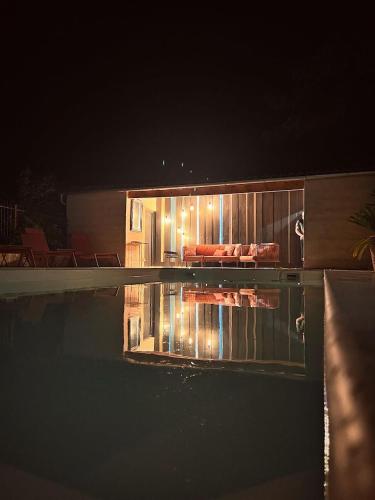 a house with a swimming pool at night at Le 240b #1 in Saint-Mard
