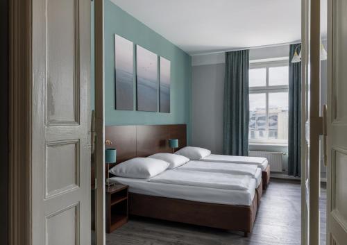 a bedroom with two beds and a window at Hotel Nova in Berlin