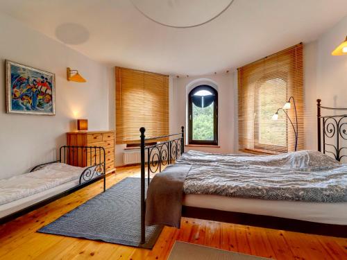 a bedroom with two beds and a window at Holiday Home Zameczek Falsztyn by Interhome in Falsztyn