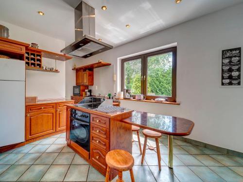 a kitchen with a table and a stove top oven at Holiday Home Zameczek Falsztyn by Interhome in Falsztyn