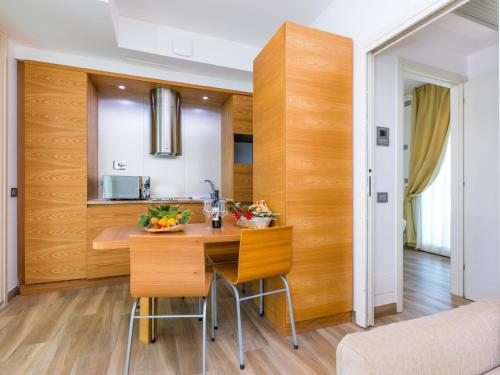 a kitchen with wooden walls and a table and chairs at Holiday Home Biovillage-6 by Interhome in Collemezzano