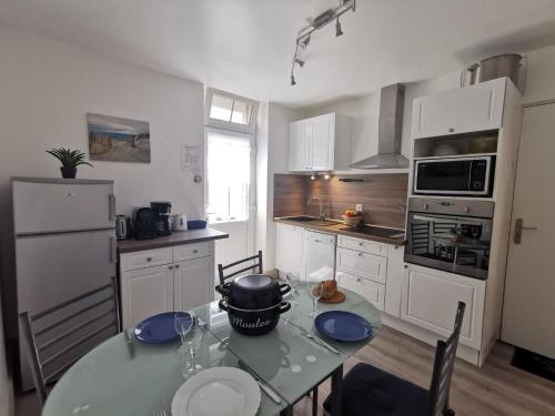 a kitchen with a table with a pot on it at Apartment La Licorne by Interhome in Saint Malo