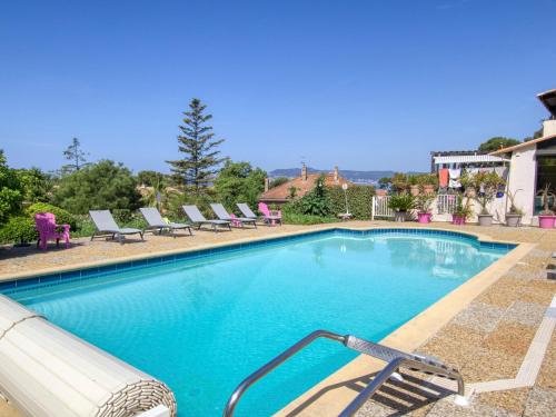 a large swimming pool with lounge chairs at Apartment La Madrague d'Azur-9 by Interhome in La Madrague