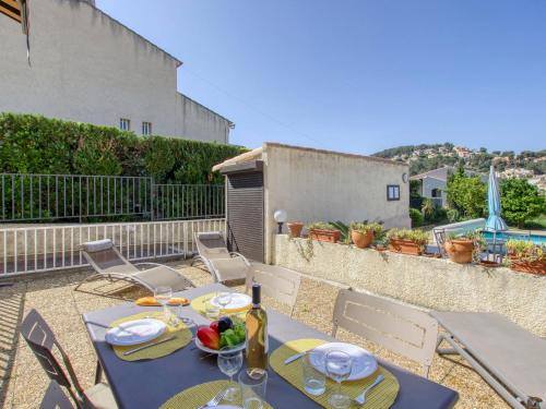 a table and chairs on the patio of a house at Apartment La Madrague d'Azur-9 by Interhome in La Madrague