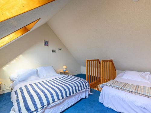 a attic bedroom with two beds in a attic at Studio Phare de Kernevest-1 by Interhome in La Trinité-sur-Mer