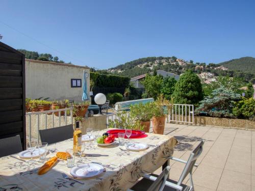 a table with a plate of food on a patio at Apartment La Madrague d'Azur-7 by Interhome in La Madrague
