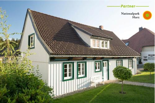 a white house with a brown roof at Ferienhaus "Am Bodeweg 1" in Schierke