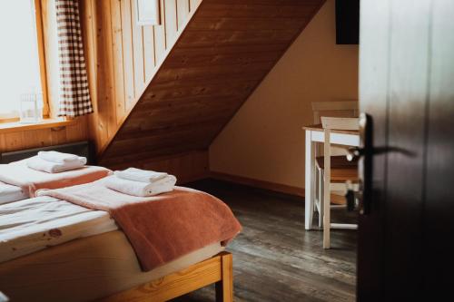 two beds in a room with a staircase at Jasminowe Wzgorze in Wilkanów