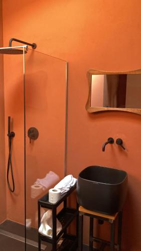 a bathroom with a black sink and a mirror at CHALET in Milan