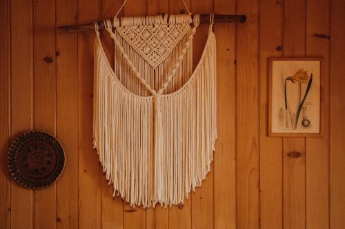 a white dream catcher hanging on a wall at Jasminowe Wzgorze in Wilkanów