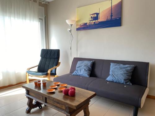 a living room with a couch and a coffee table at Apartment Roger de Flor-1 by Interhome in Llança