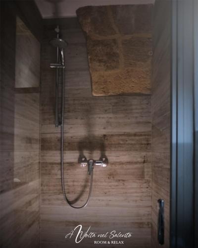 a shower with a shower head in a bathroom at AvVolta nel Salento - Room & Relax in Torchiarolo