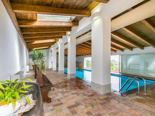 an empty lobby with a pool and wooden ceilings at Holiday Home Grotte Rosse by Interhome in Cinigiano