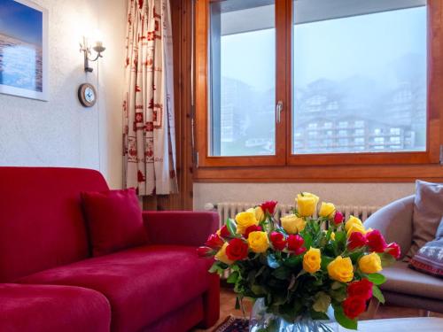 a living room with a vase of flowers on a table at Apartment Ecluses 2 by Interhome in Nendaz