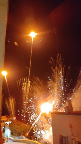 a street light with fireworks in a city at night at DIMORA STORICA ALLA ROTONDA in Mottola