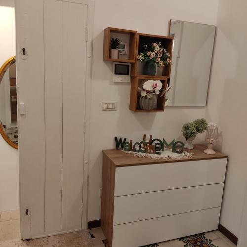 a dressing room with a dresser and a mirror at DIMORA STORICA ALLA ROTONDA in Mottola