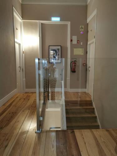 a glass display case in a room with stairs at Temple Suites Guesthouse in Portimão