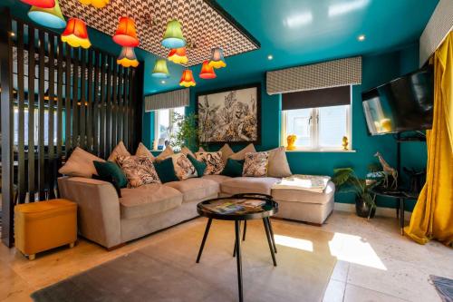 a living room with a couch and a table at Trewhiddle Retreat V3 by Together Travel - Luxury 4-Bedroom Villa in St Austell
