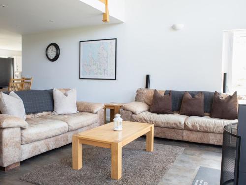 a living room with two couches and a coffee table at Holiday Home One Mill Lands by Interhome in Uig