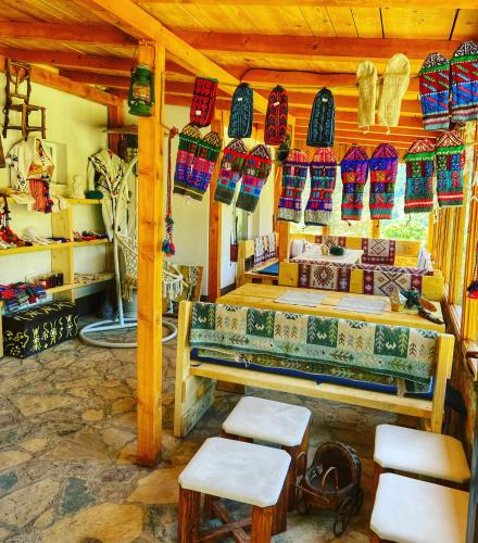 a room with a table and chairs and colorful items at Konak Umoljani in Umoljani