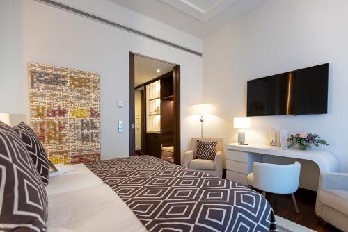 a hotel room with a bed and a desk at Hospes Amérigo, Alicante, a Member of Design Hotels in Alicante