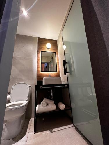a bathroom with a toilet and a sink and a mirror at Up Barrio Norte in Buenos Aires