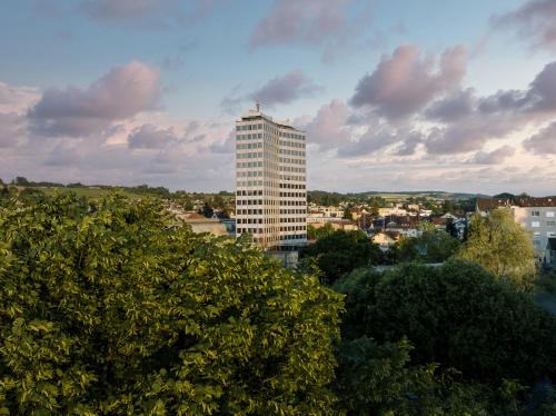a tall building in the middle of a city at b-smart hotel Menziken in Menziken