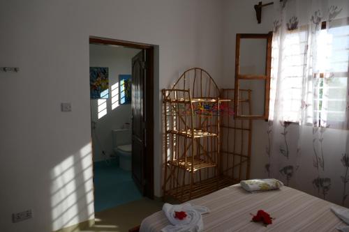 a room with a bedroom with a bed and a bathroom at Villa Francesca Boutique Hotel in Uroa