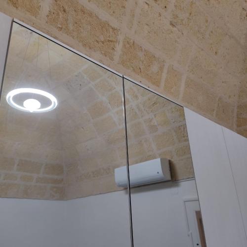 a ceiling with a light and a glass door at DIMORA STORICA ALLA ROTONDA in Mottola