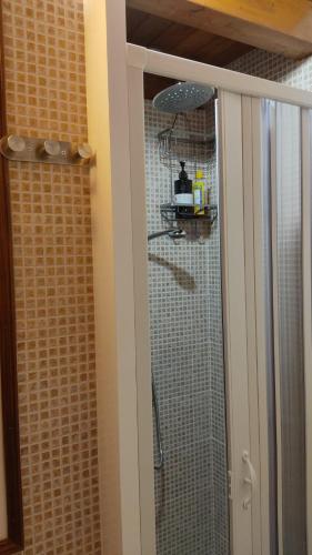 a shower in a bathroom with a glass door at DIMORA STORICA ALLA ROTONDA in Mottola