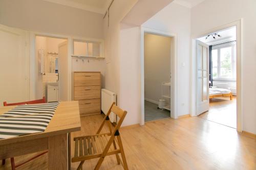 a kitchen and dining room with a table and a room at Retro Apartmentments Łobzowska street in Krakow