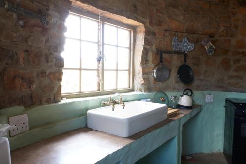 a white sink in a kitchen with a window at Rangers Reserve in Touwsrivier