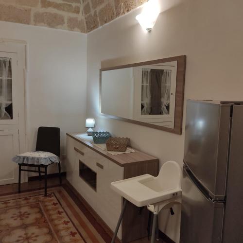 a kitchen with a refrigerator and a sink at DIMORA STORICA ALLA ROTONDA in Mottola