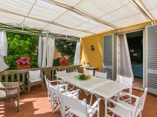 a white table and chairs on a patio at Villa Il Belvedere by Interhome in Lari