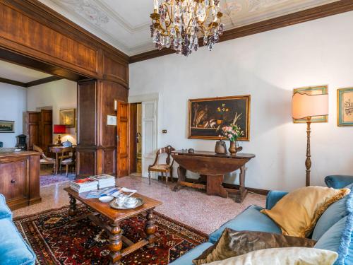 a living room with a blue couch and a table at Villa Il Belvedere by Interhome in Lari