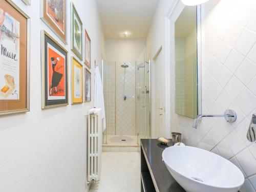 a white bathroom with a sink and a shower at Villa Il Belvedere by Interhome in Lari
