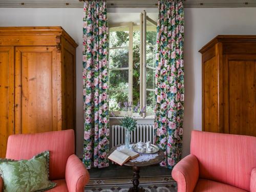 two chairs and a table in a room with a window at Villa Il Belvedere by Interhome in Lari