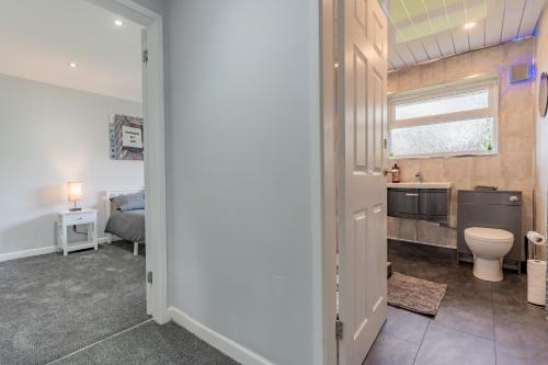 a bathroom with a sink and a toilet in a room at Jodi's Bungalow - Garden and Parking in Nottingham