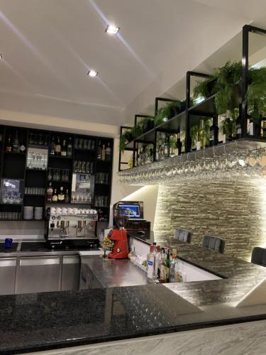 a kitchen with a counter and a bar at Hotel FOCUS in Prilep