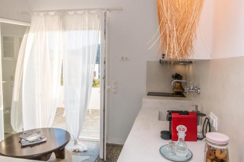 a kitchen with a table and a glass door at Saffron Boutique in Krokos
